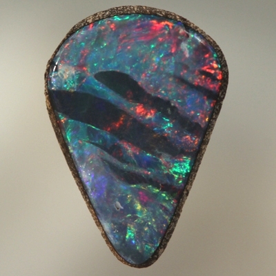 SOLID BOULDER OPAL Bright red and green surround black opal bands 